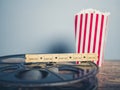 Old film reel, popcorn and tickets Royalty Free Stock Photo