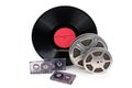 Old film reel with strip , photographic film, audio recordings and vinyl records Royalty Free Stock Photo