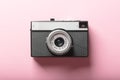 Old film retro camera on pink background