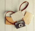 Film retro camera and several blank backgrounds on rough wooden table Royalty Free Stock Photo