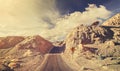 Old film retro stylized rocky desert road.