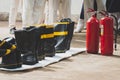 Old fire boots and Fireman with fire extinguisher. Royalty Free Stock Photo