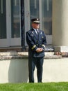 Old fire chaplain in uniform stands with hands folded at a memorial day commemoration