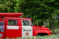 An old fire engine in an open-air museum. White and red car on the background of green trees. Royalty Free Stock Photo