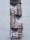 Old fire escape installed outside the old apartment Royalty Free Stock Photo