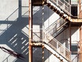 Old fire escape staircase installed on building wall. Royalty Free Stock Photo