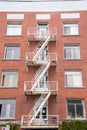 An old fire escape stairs on the side of a building. Royalty Free Stock Photo