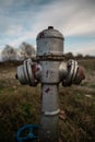Old fire hydrant on a field of grass filled with rust Royalty Free Stock Photo
