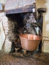 Old fireplace with hanging copper pot Royalty Free Stock Photo