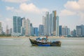 Old fisher boats in front of modern skyscraper city skyline in P Royalty Free Stock Photo