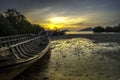 Old fisherman boat on beach and sunset scene Royalty Free Stock Photo