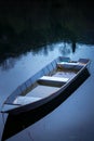 Old fisherman boat on the lake at night