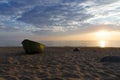 Old fisherman boat at sunset time. Sunset at the Baltic Sea Beach. Royalty Free Stock Photo