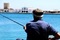 Old Fisherman Fishing in Greece - close up