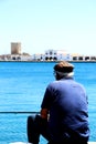 Old Fisherman Fishing in Greece - close up