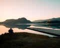 Old fisherman fishing on lake Bled on a sunny spring day Royalty Free Stock Photo