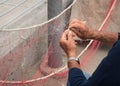 Old fisherman is fixing a fishing net