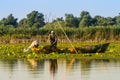 Old fisherman gathering nets in Danube Delta Romania. Traditional fishing .