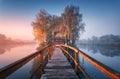 Old fisherman house and wooden pier at foggy morning in autumn