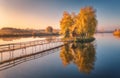 Old fisherman house and wooden pier at sunrise in autumn Royalty Free Stock Photo