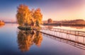 Old fisherman house and wooden pier at sunrise in autumn