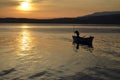 An old fisherman on the lake at sunrise Royalty Free Stock Photo