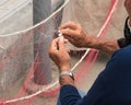 Fisherman is fixing a fishing net