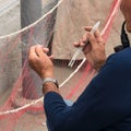 Fisherman is fixing a fishing net