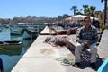 Old fisherman resting on the bench