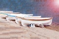 Old fisherman`s boats on white beach on warm sunset and copy spase.