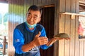 Old fisherman show stingray crab in his hands Royalty Free Stock Photo