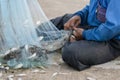 Old Fishermen clearing fisherman net , a lot of small fish Royalty Free Stock Photo