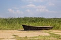 Old fishing boat on asphalt on the background of reeds Royalty Free Stock Photo