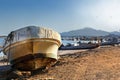 Old fishing boat on the beach in the port of Kalba