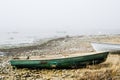 Old fishing boat at coast foggy in the morning Royalty Free Stock Photo