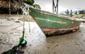 Old fishing boat is moored on beach at low tide. Royalty Free Stock Photo