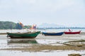 An old fishing boat moored beached on the beach at low tide. Royalty Free Stock Photo