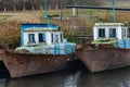 Old fishing boat moored at the pier. Rusty iron ship. Dump on the river or other reservoir. Used and abandoned fishery equipment Royalty Free Stock Photo