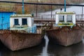 Old fishing boat moored at the pier. Rusty iron ship. Dump on the river or other reservoir. Used and abandoned fishery equipment Royalty Free Stock Photo