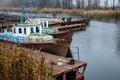 Old fishing boat moored at the pier. Rusty iron ship. Dump on the river or other reservoir. Used and abandoned fishery equipment Royalty Free Stock Photo