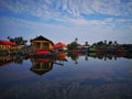 Old fishing boat near wooden jetty. Beautiful malaysian landscape. Sunset reflection in the water. Royalty Free Stock Photo