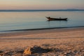 Old fishing boat on a sand beach, sunset Royalty Free Stock Photo