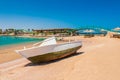 Old fishing boat on sand with blue sky and water Royalty Free Stock Photo