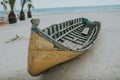 Old fishing boat on sand with blue sky and water Royalty Free Stock Photo