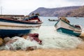 Old fishing boat on the shore. Boat with nets waiting for fishermen on the beach of Cape Verde