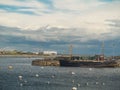 Old fishing boat and white swans colony, Claddagh, Galway city, Ireland, Cloudy sky Royalty Free Stock Photo