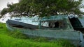 Old Fishing boat in windy grass along the shoreline