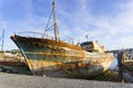 Old fishing boat wrecks stranded and left on a rocky beach