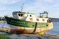 Old fishing boat wrecks stranded and left on a rocky beach