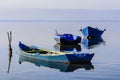 Old fishing boats with bright colors at dawn on the lake Royalty Free Stock Photo